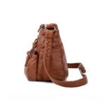 Exterior silt pocket detail on the women's messenger bag