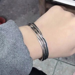 Close-up of the adjustable opening on the silver braided bangle