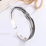 Elegant party-ready look featuring the trendy geometric silver bracelet
