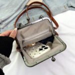 Model carrying the handbag as a crossbody