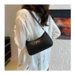 Front view of women's PU leather shoulder bag with bow accent